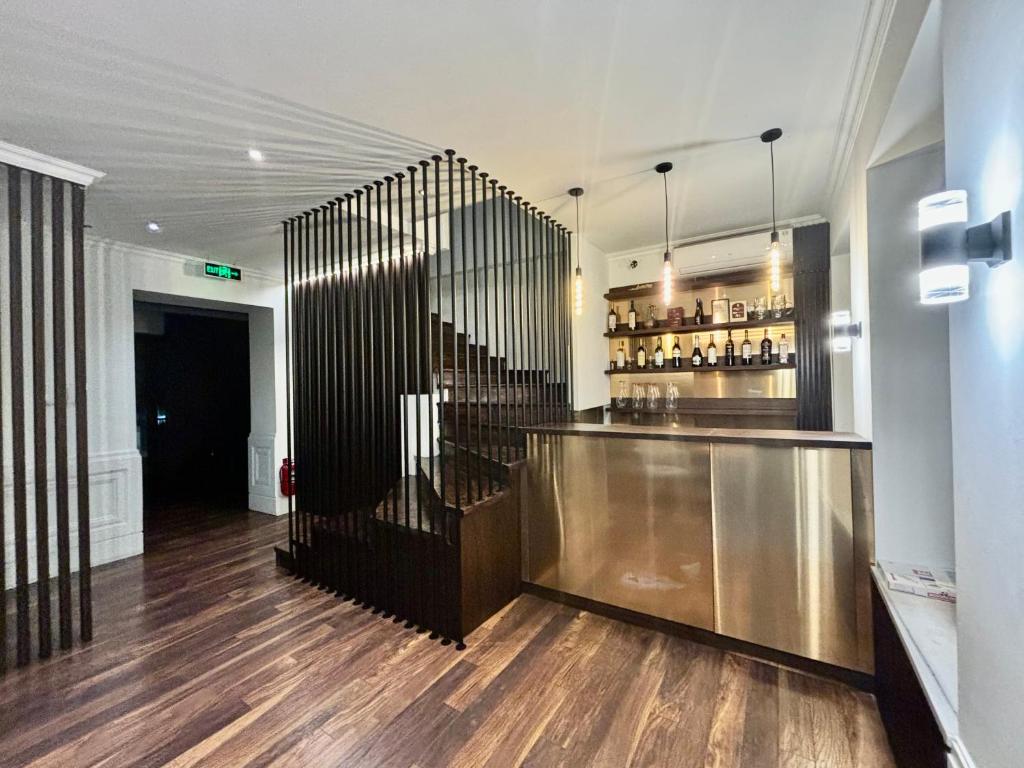 a lobby with a bar and a staircase in a building at D and D hotel in Tbilisi City