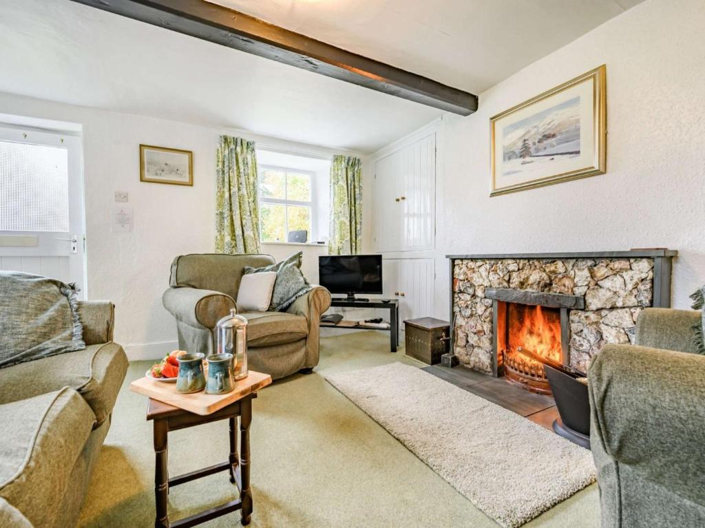 a living room with a fireplace and a tv at 2 Bed in Borrowdale SZ302 in Rosthwaite