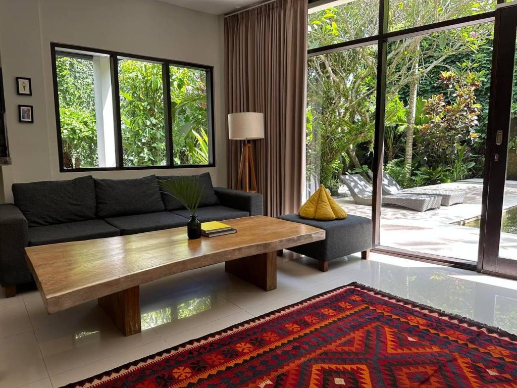 a living room with a couch and a coffee table at Surf House Santai Villa Balian in Tabanan