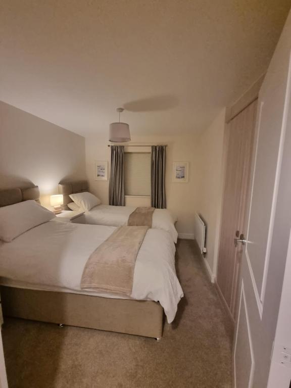 a large bedroom with two beds and a window at Estuary view in Fleetwood