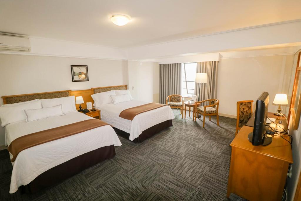 Postel nebo postele na pokoji v ubytování Hotel Miramar