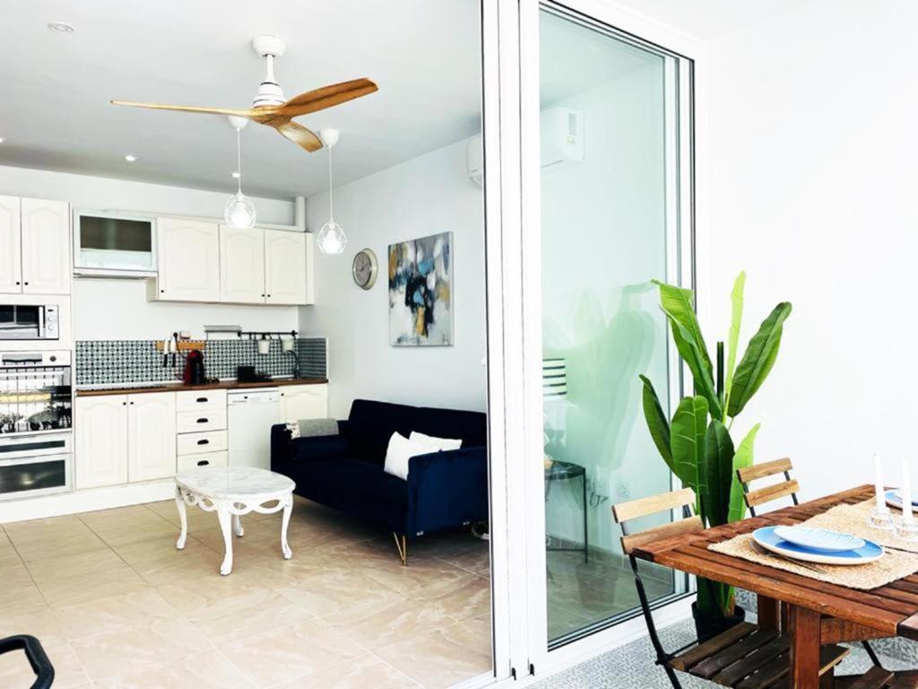 a living room with a blue couch and a table at Apartamentos ALAZUL JRJ in Conil de la Frontera
