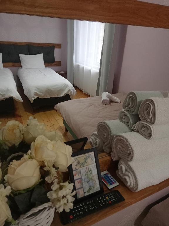 a hotel room with two beds and a table with towels at Принцеса Анастасия 2 in Chiprovtsi