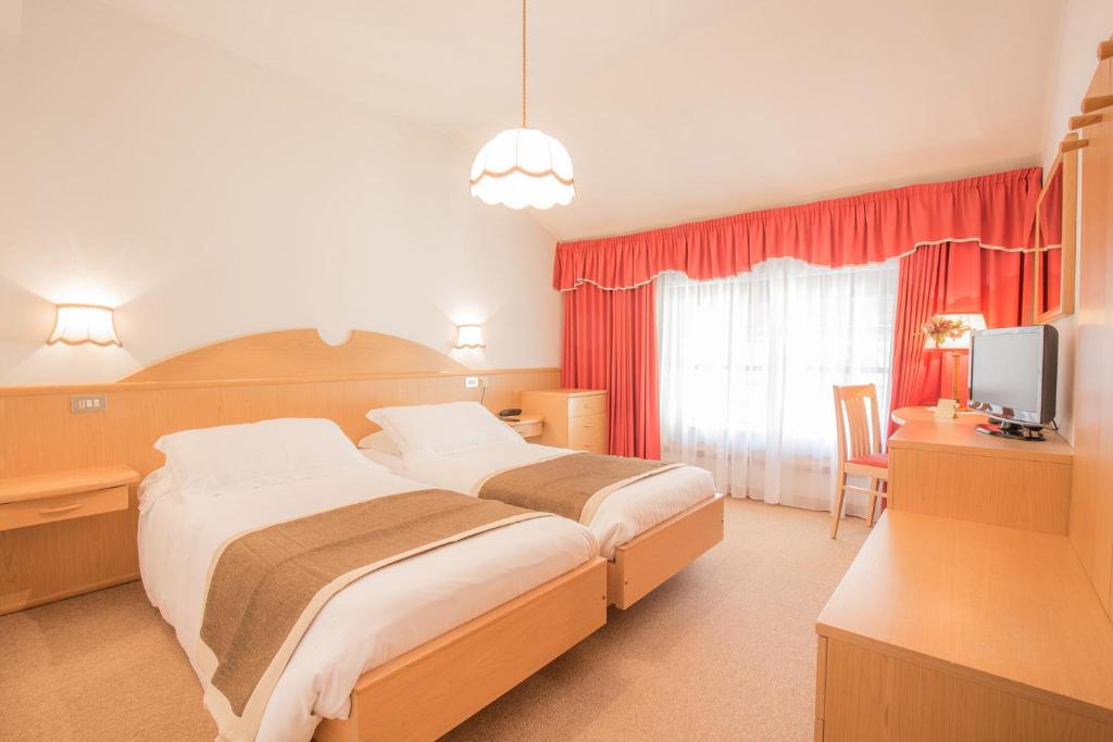 Postel nebo postele na pokoji v ubytování Hotel Villa Trieste