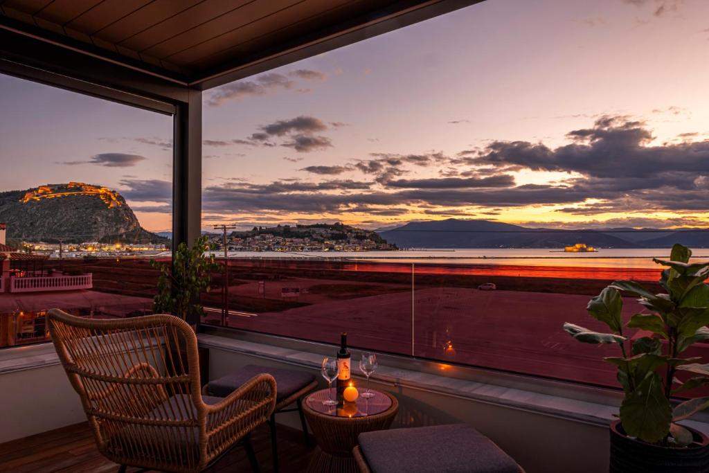 a room with a window with a view of the ocean at Harmony Rooms Nafplio in Nafplio