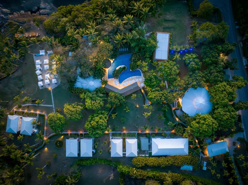 an aerial view of a resort with a pool and trees at Azul Hotel & Retreat in Playa Azul