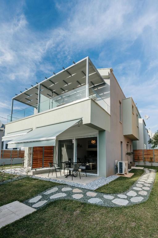 a modern house with a large glass roof at Aegean Twin Houses in Iraklitsa