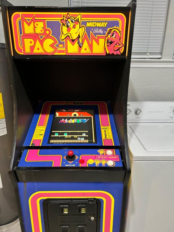 an arcade game in a box with a pokemon pay machine at The Jewel of Jacksonville in Jacksonville