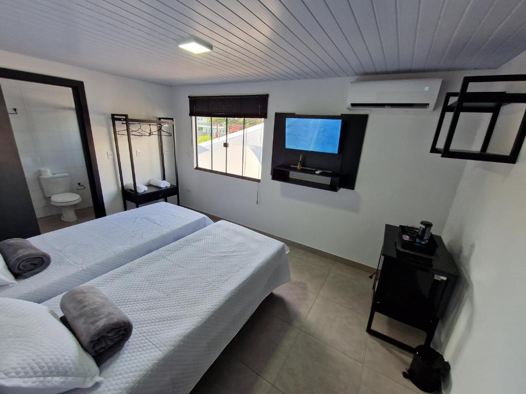 Postel nebo postele na pokoji v ubytování Condomínio Inn Studio