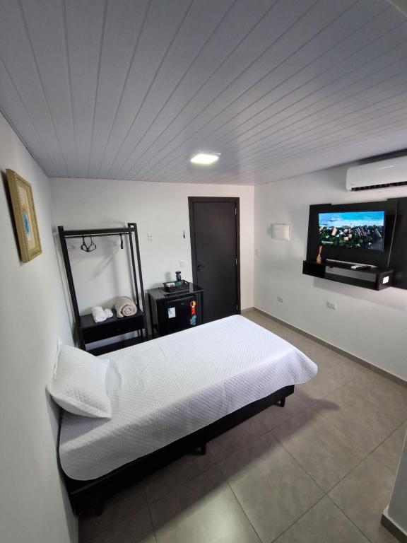 Postel nebo postele na pokoji v ubytování Condomínio Inn Studio