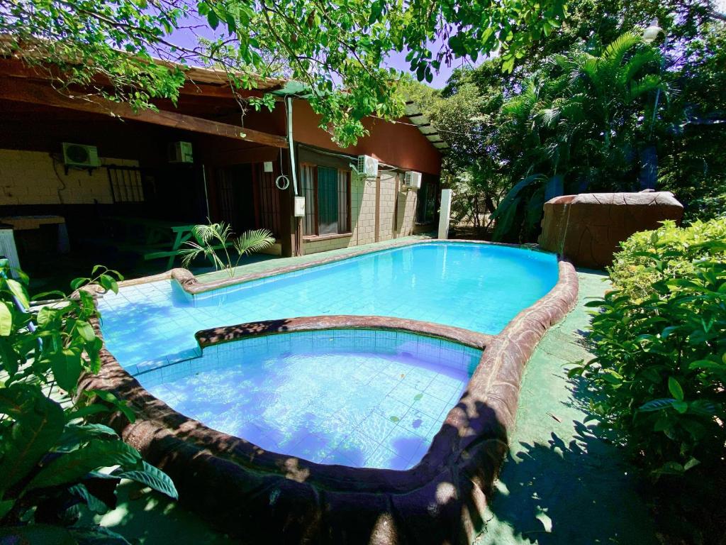 a swimming pool in a yard next to a house at Casa Pochotal in Cartagena