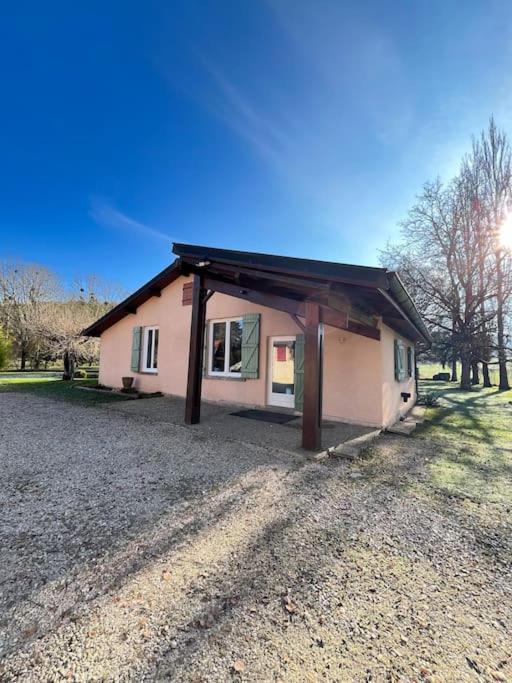 une petite maison rose avec un toit noir dans l'établissement Maison au bord de rivière, à Gissey-sur-Ouche