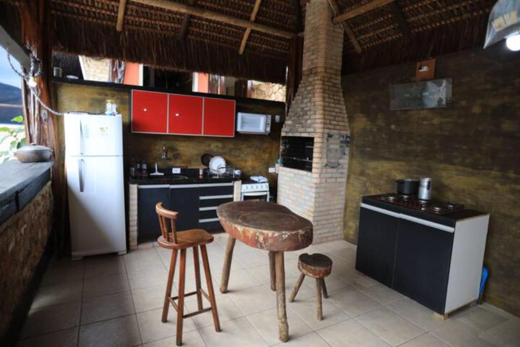 a kitchen with a white refrigerator and a stove at Espaço Verano- Master 1 in Niterói