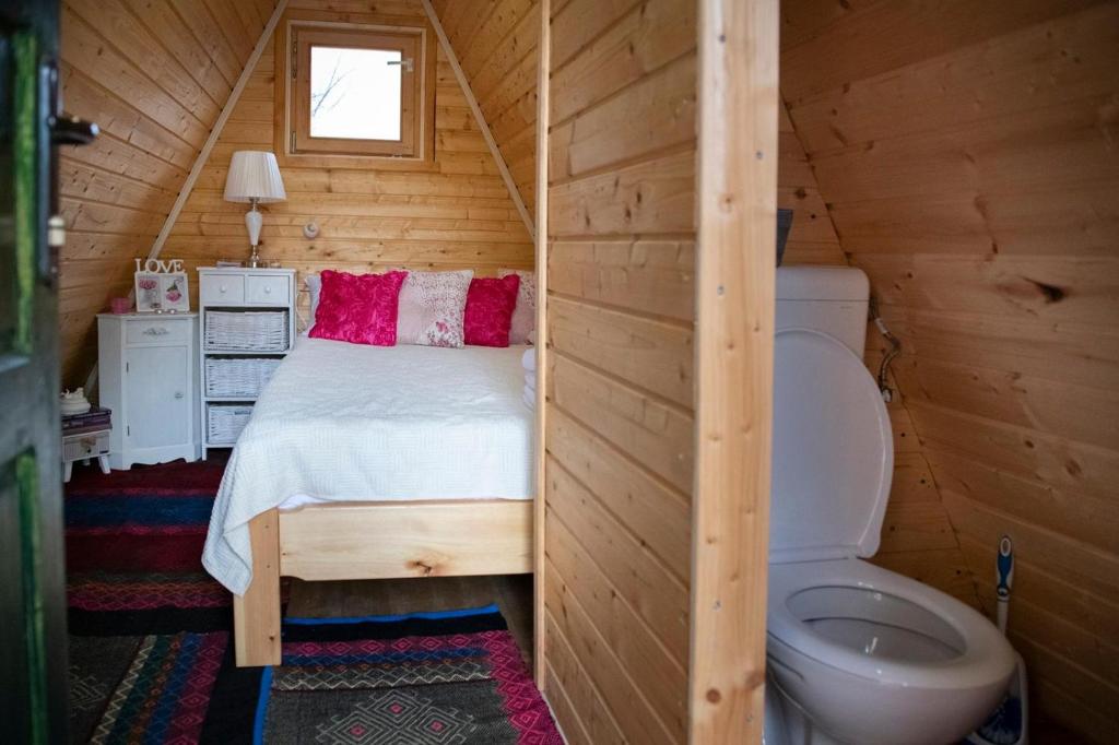 a bedroom with a bed and a toilet in a room at STD SRCE KAMENE GORE in Kamena Gora