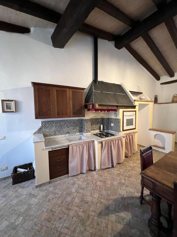 a kitchen with a table and a stove top oven at Á Ćà de Matilde in Ranzo-Borgo