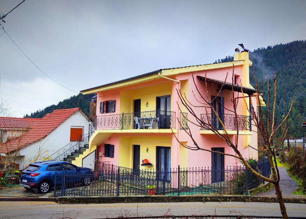 a house with a car parked in front of it at Villa Athamanio - Premium in Athamanio