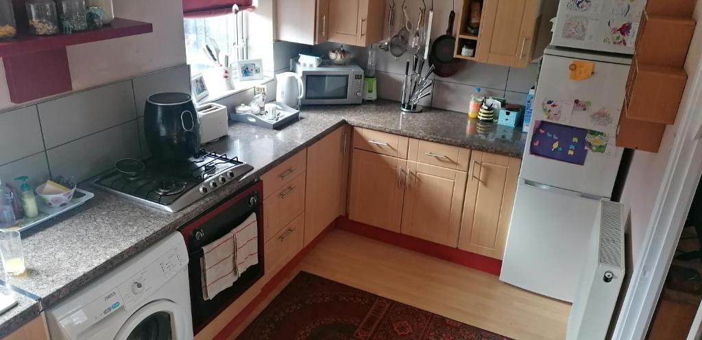 a kitchen with a stove and a refrigerator at Lawford Close in Madeley