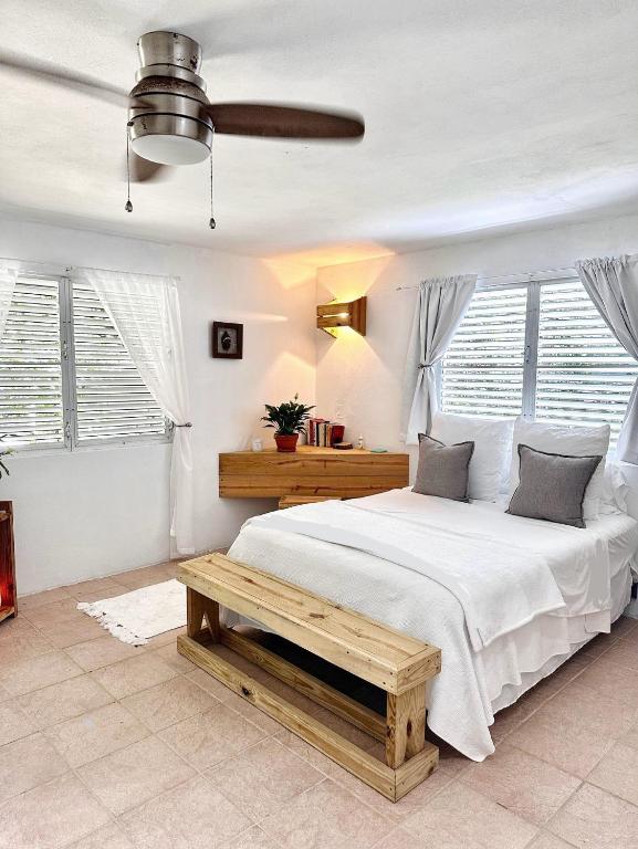 a bedroom with a large bed with a wooden bench at Hacienda Verde Luz 