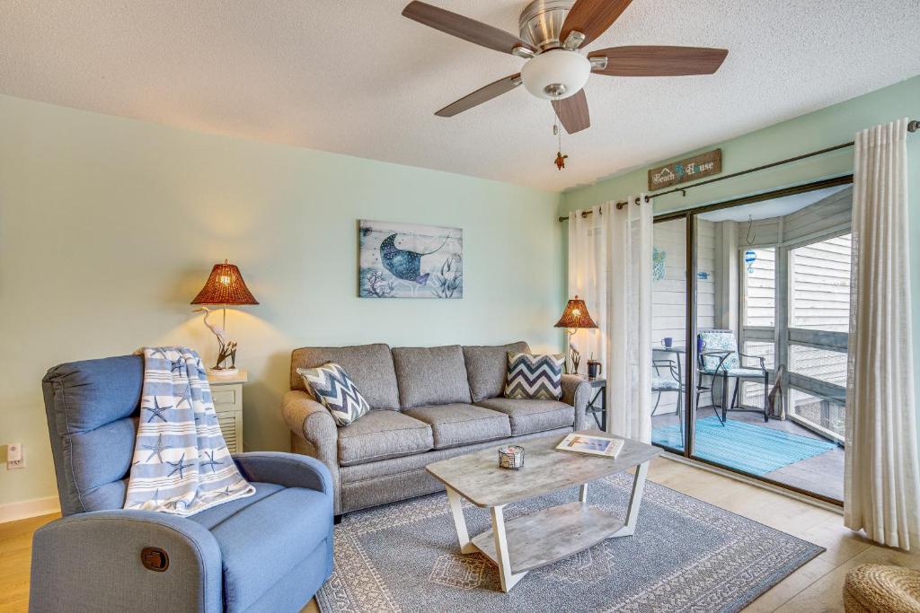 a living room with a couch and a table at Saint Helena Island Condo - Steps to Beach! in Oceanmarsh Subdivision