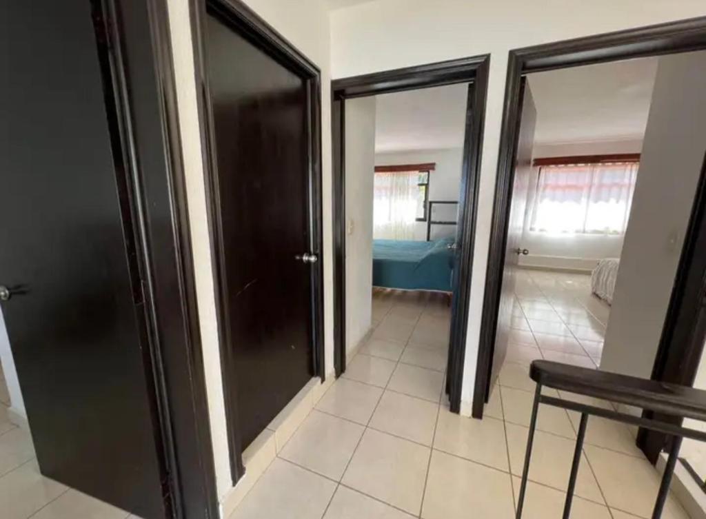 a room with two sliding doors and a bedroom at Chakalito in Tonalá