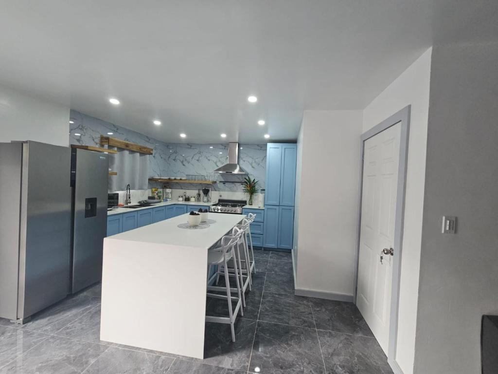 a kitchen with blue cabinets and a white counter top at Casa Margarita in First Bight