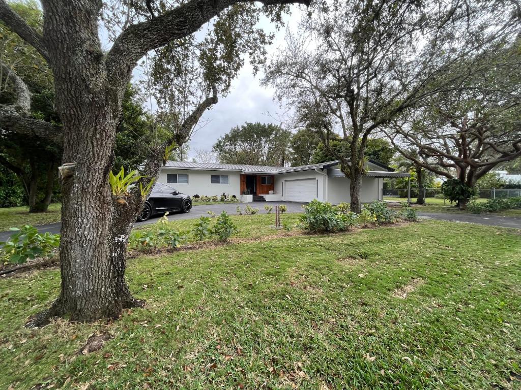 una casa con un árbol en el patio en Family 4br Home Near Dadeland Mall en Miami