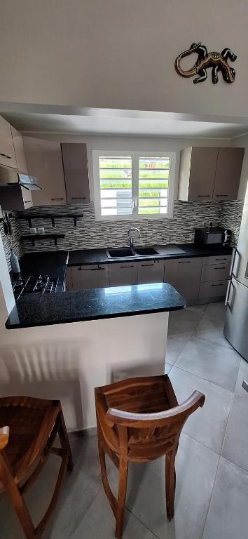 a kitchen with a sink and a counter top at LOCATION LA MONTAGNE MARTINIQUE in Le Vauclin