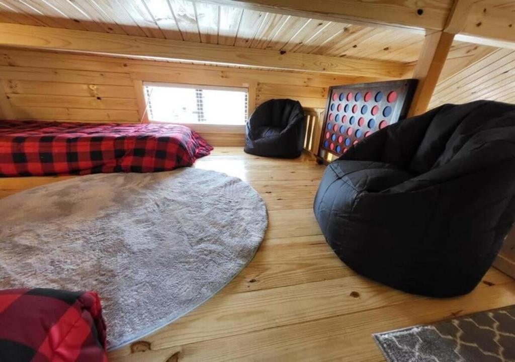 a living room with two beds and a rug at Picturesque Family Cabin with Loft in Tennessee in Sevierville