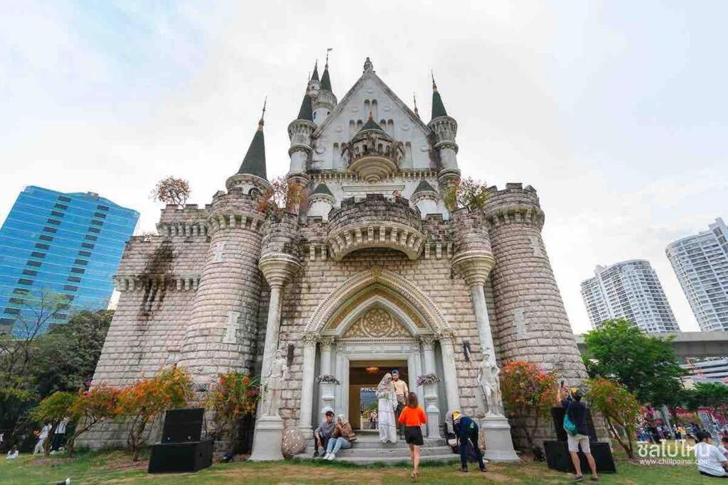 a castle building with people standing in front of it at 6Pax House 6mins walk BTS,15mins drive DMK airport in Bangkok