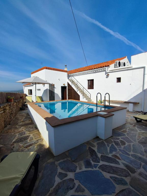 a swimming pool on top of a house at Casa Tia Xica in Monsaraz