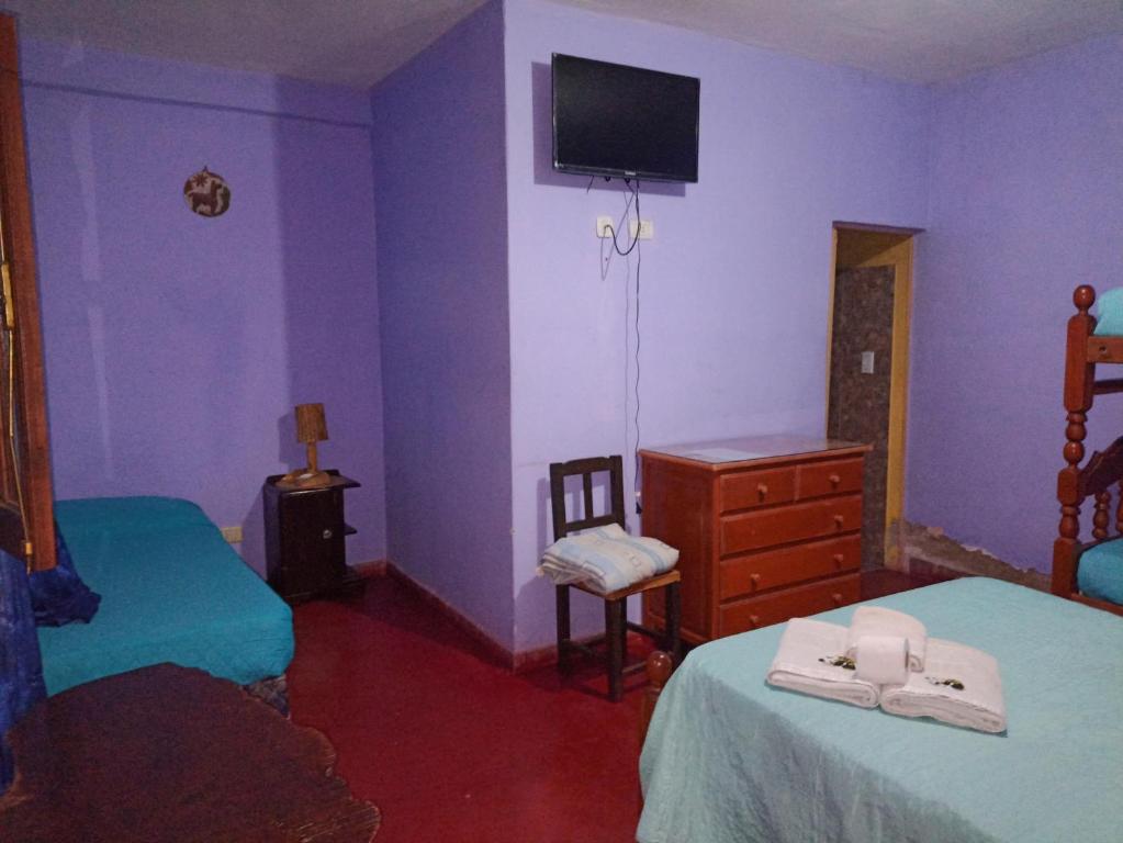 Postel nebo postele na pokoji v ubytování Hostal Benjamin