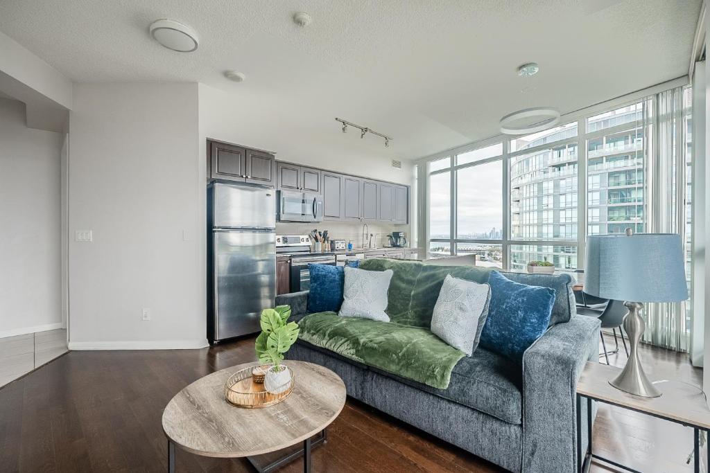 a living room with a couch and a table at RivetStays - The Neptune in Toronto