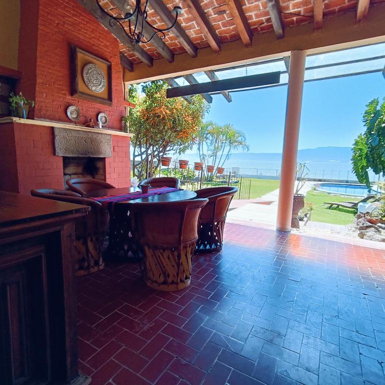 a patio with a bar with a view of the ocean at VILLA DOÑA CONCHITA in Ajijic