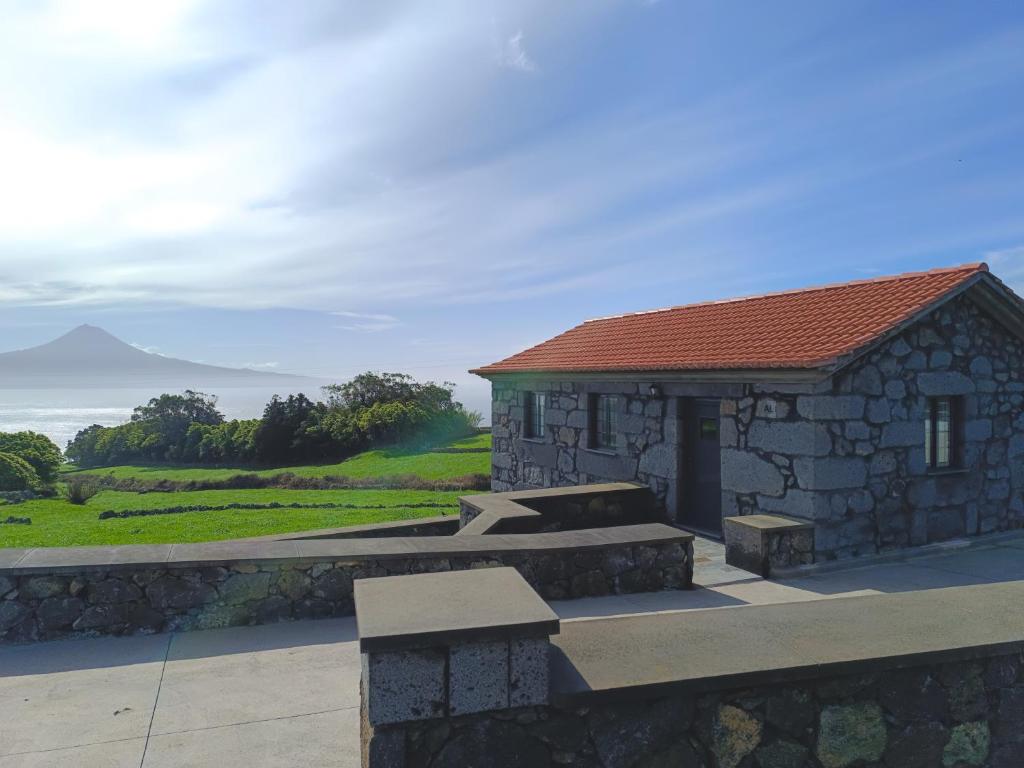 a stone building with a bench in front of it at Laura's Cottage AL in Velas
