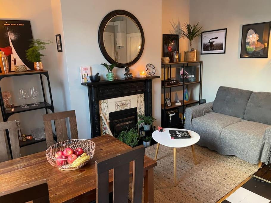 sala de estar con sofá, mesa y espejo en Cozy Studio Rialto en Dublín