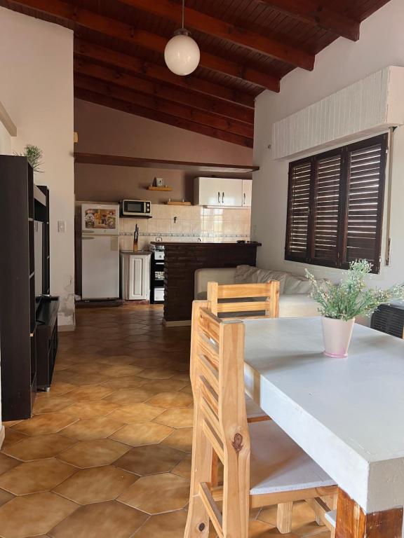 a kitchen and living room with a table and chairs at ALQUILER LAS FLORES in Las Flores