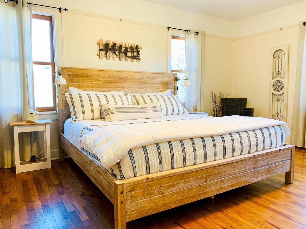 a bedroom with a large bed with a wooden headboard at Riverpath Inn in Eugene