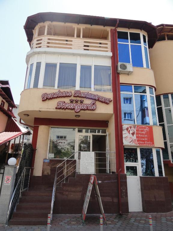 a building with a sign on the front of it at Pensiune Restaurant Avangarde in Piteşti