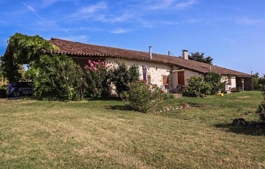 a house with a grass yard in front of it at Pet Friendly Home In Armillac With House A Panoramic View in Armillac