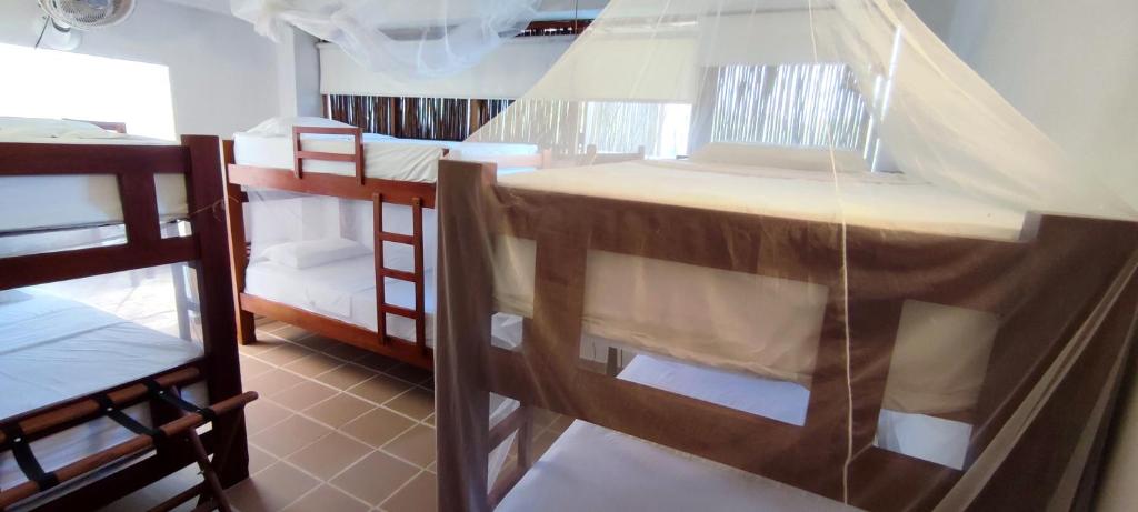 a group of bunk beds in a room at Hostal Casa en la Ciénaga in San Onofre