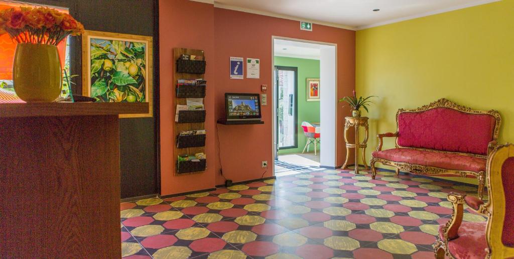 TV a/nebo společenská místnost v ubytování Rossi Hôtel