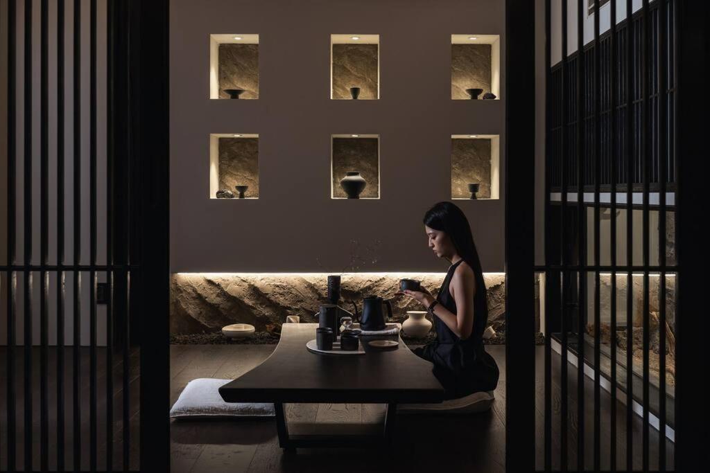 a woman sitting at a table in a room at Yeojuhyeon in Daegu