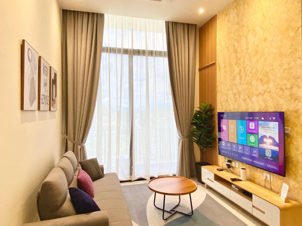 Il comprend un salon doté d'un canapé et d'une télévision à écran plat. dans l'établissement The Podium-12 Pax, à Kuching