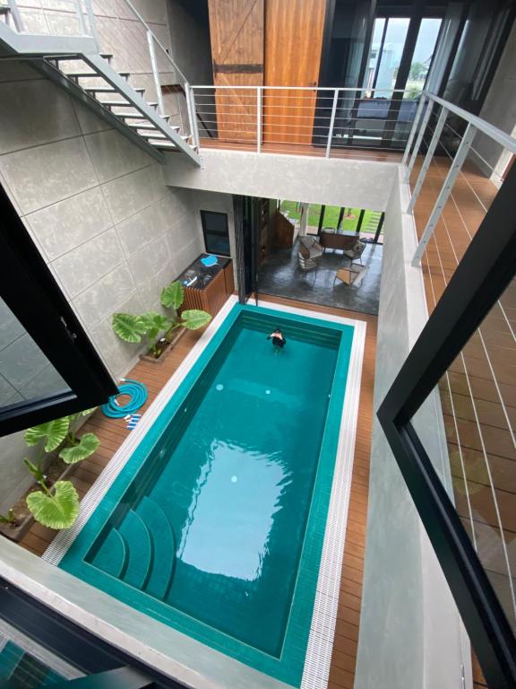 an overhead view of a swimming pool in a house at Villa AZJA PD in Port Dickson