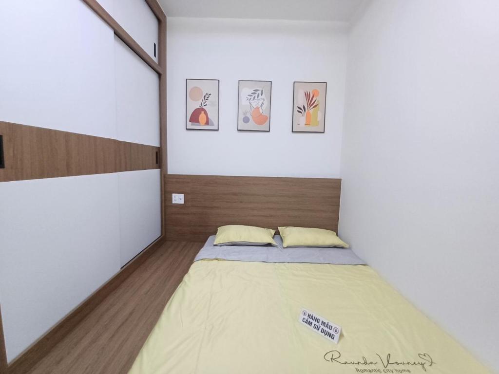 a small bedroom with a bed in a room at Mami House - Luxcity Cẩm Phả Serviced Apartments in Cẩm Phả