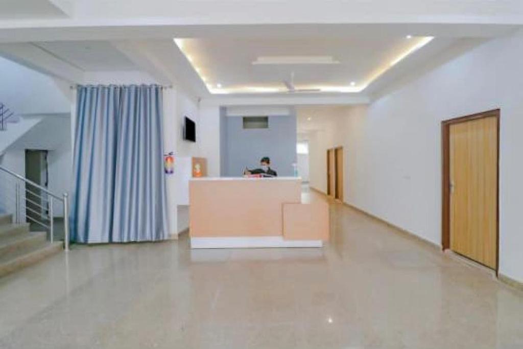 a hallway of a hospital with a person in the distance at OYO Flagship Hotel Soho in Noida