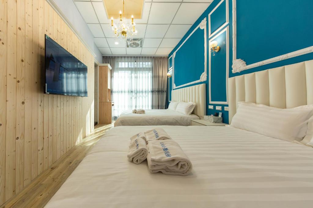 Postel nebo postele na pokoji v ubytování EZ STAY Yancheng
