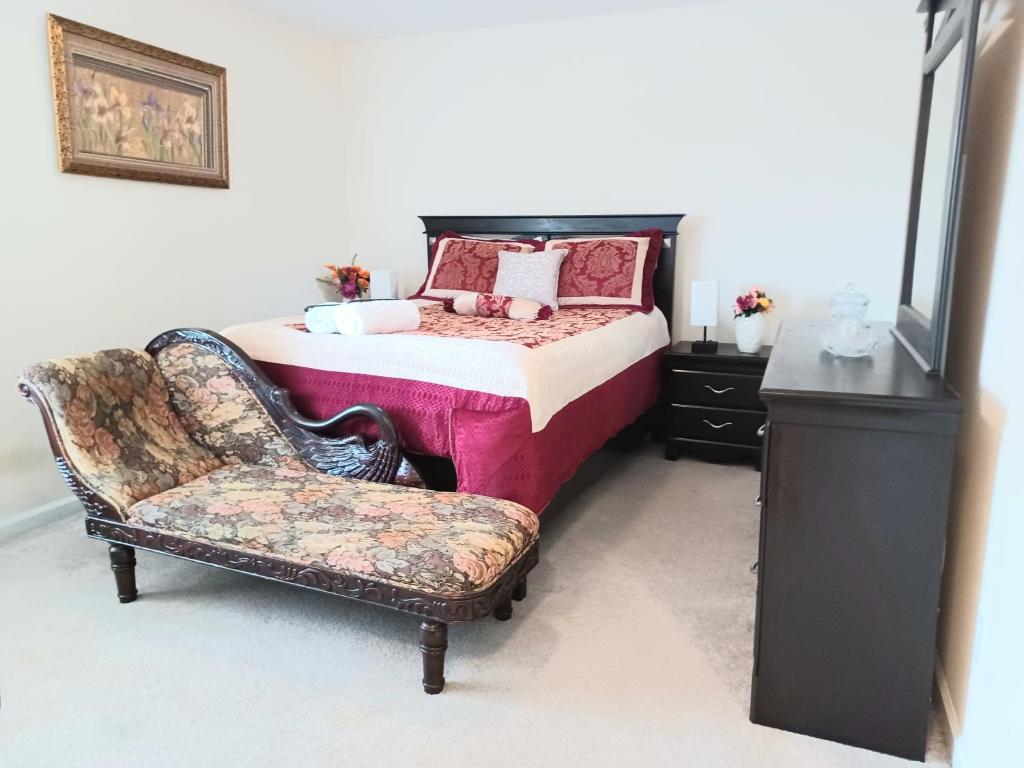 a bedroom with a bed and a chair at Luxury Suite in Austell