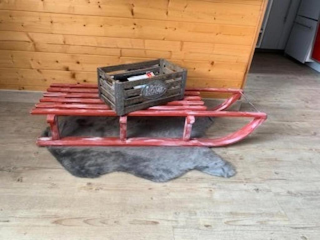 a red cart with a box on top of it at Résidence Les Temples du Soleil - maeva Home - 2 Pièces 5 Personnes Sélect 52 in Val Thorens