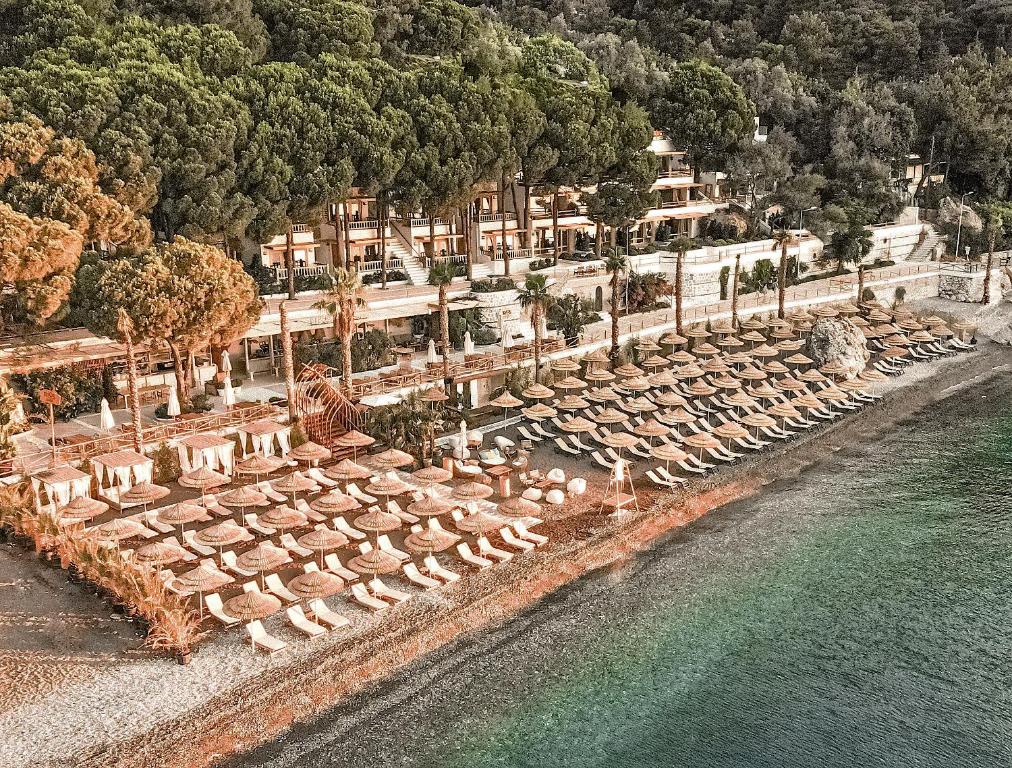 an overhead view of a beach with chairs and the water at Perios Beach House - Adults Only in Turunc